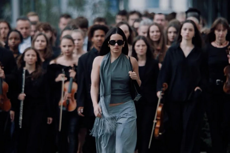 Rosalía surrounded by musicians