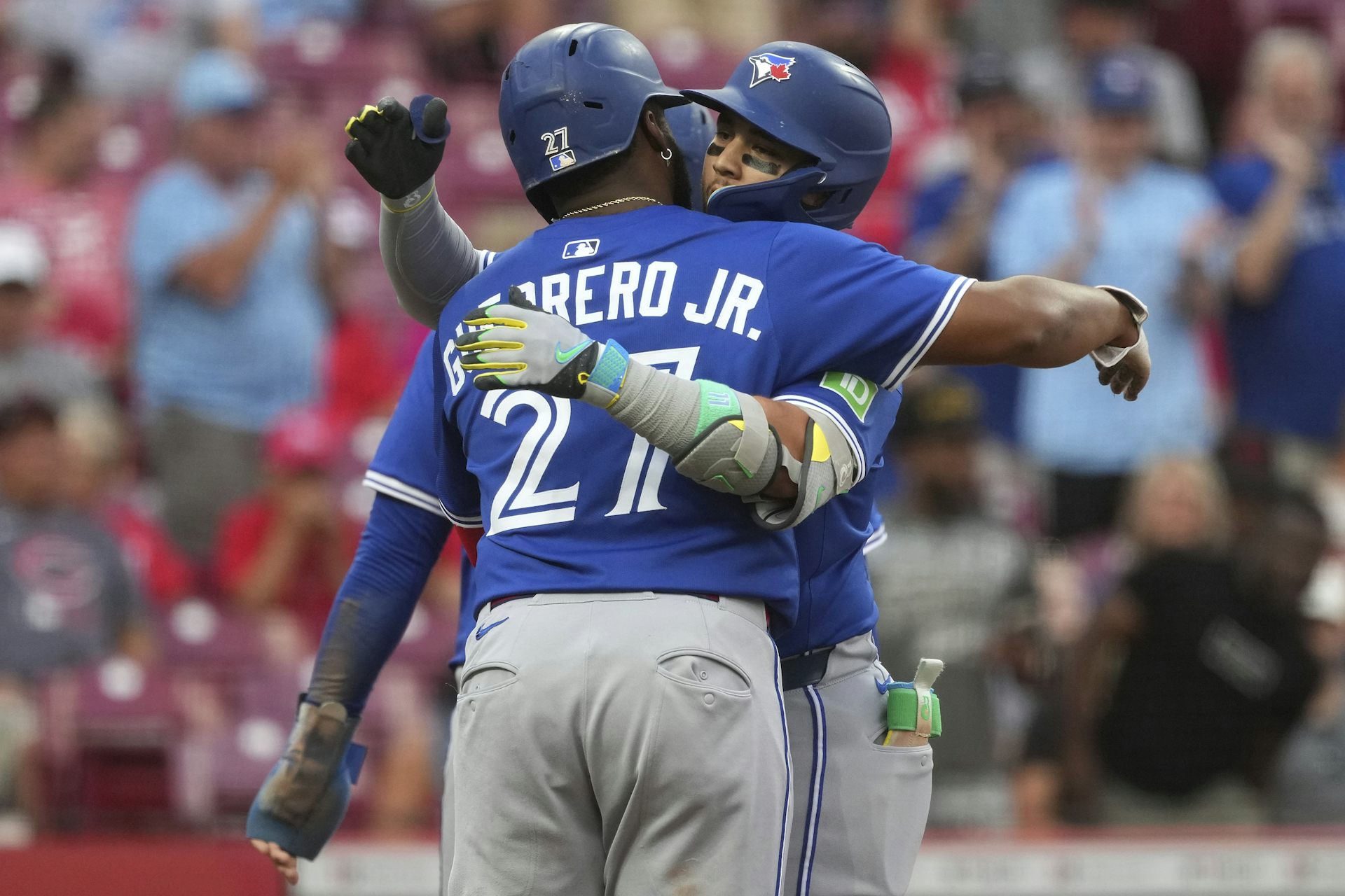 Two baseball players hug.