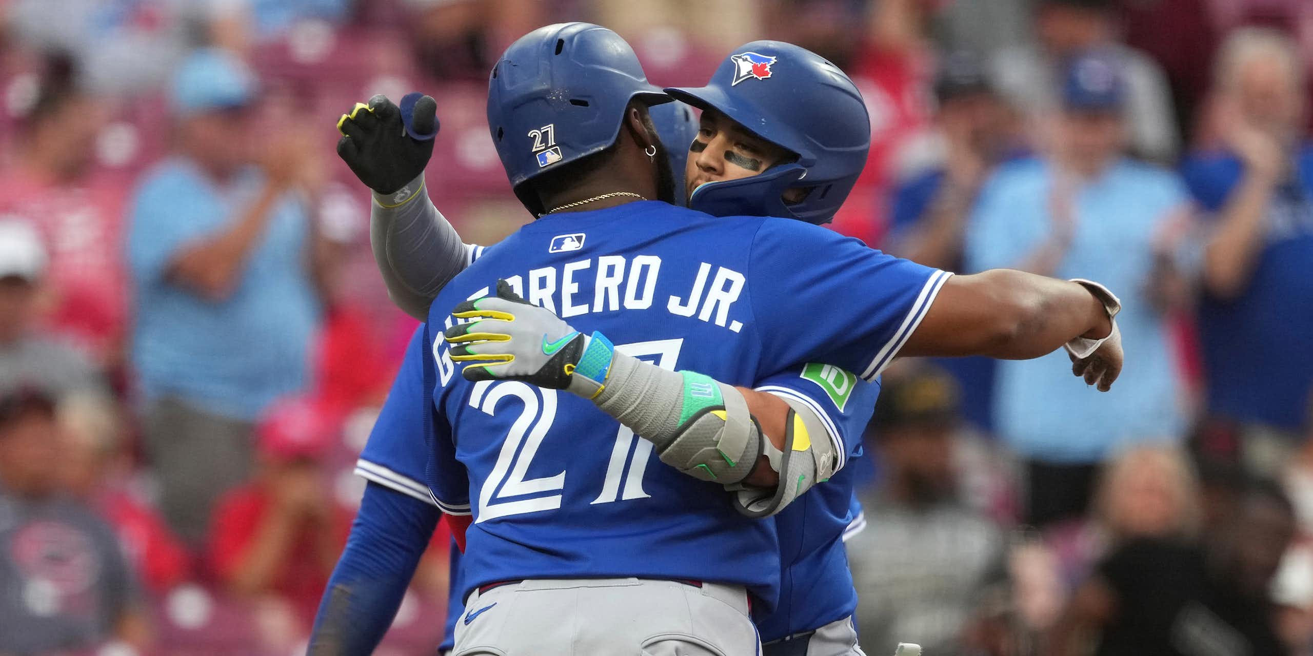 Two baseball players hug.