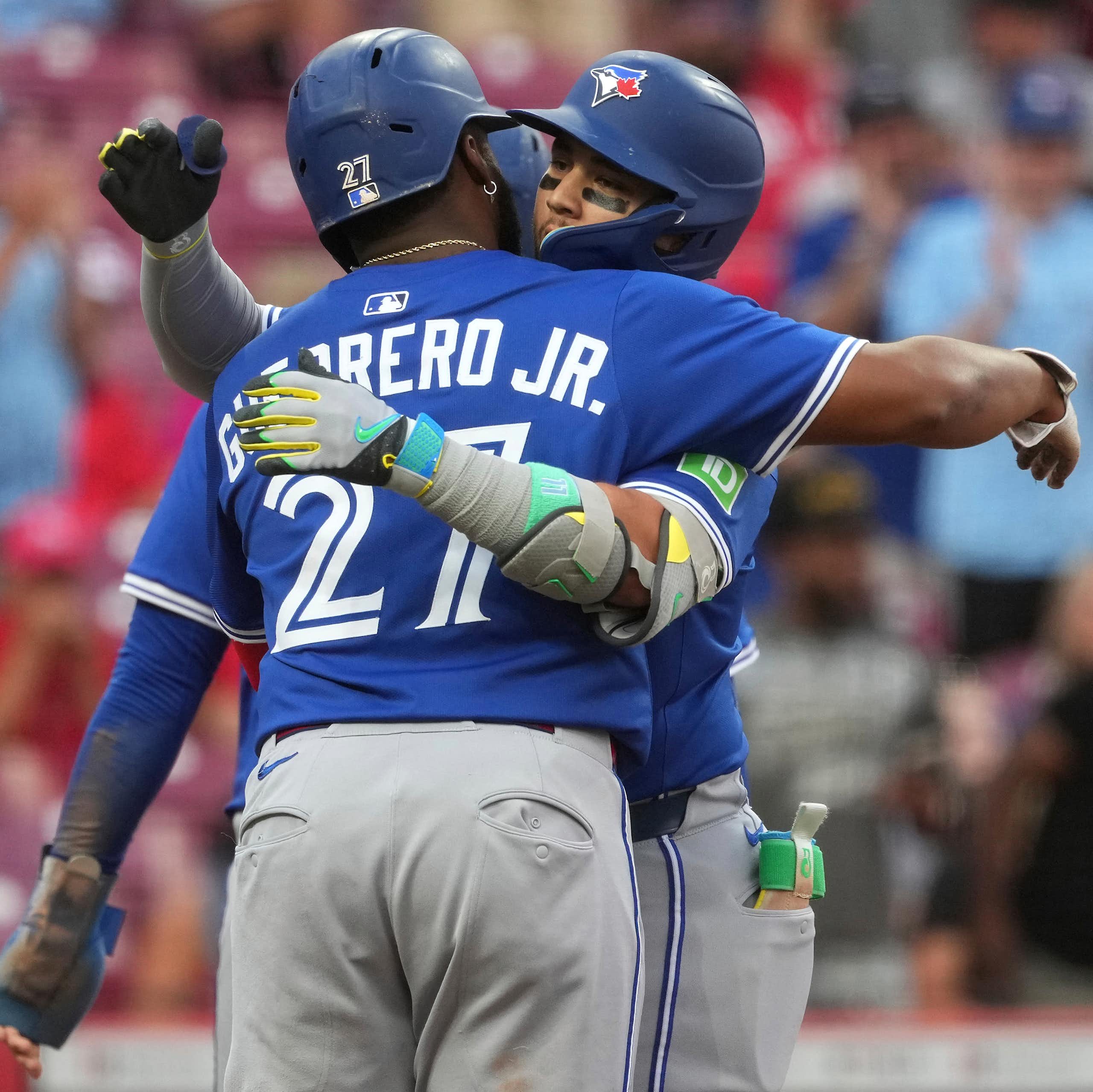 Two baseball players hug.