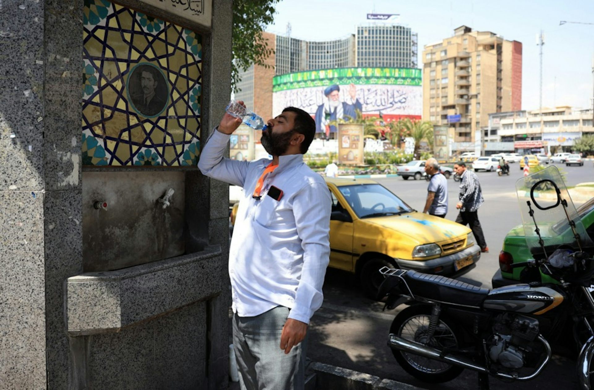A man drinks from a bottle of water.