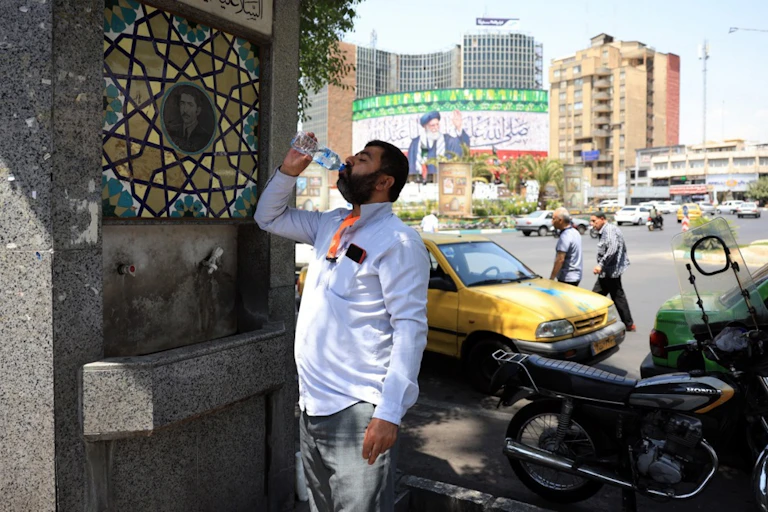 A man drinks from a bottle of water.