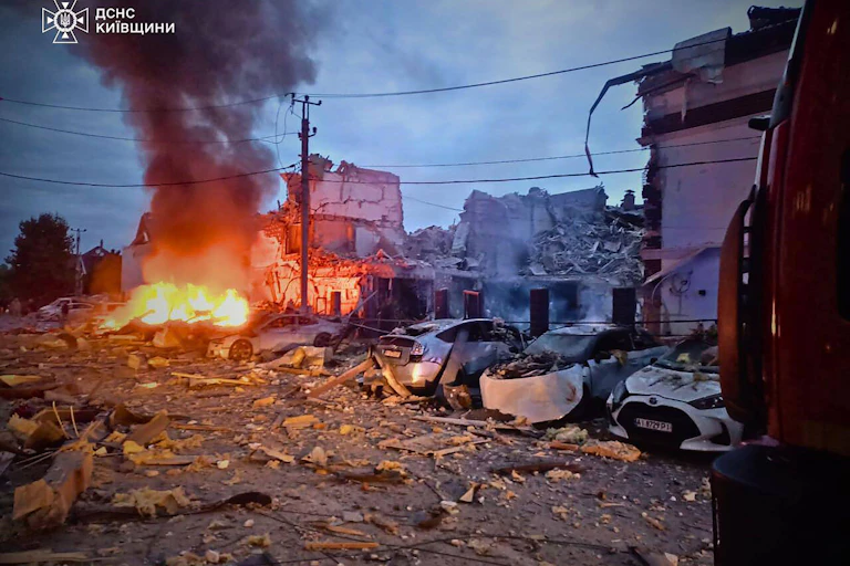 Burning cars and bomb-damaged houses in Kyiv.