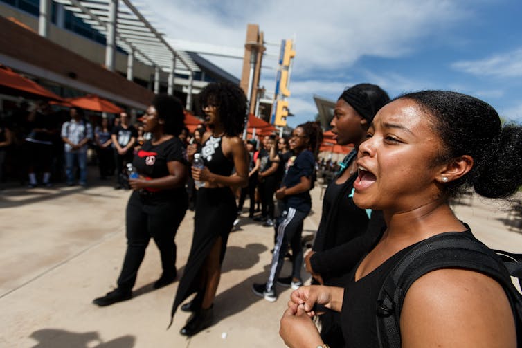 Black scholar unions are below force – right here’s what they do and the way they assist Black scholars in finding neighborhood 1 A group of young Black women stand together and appear to be shouting.