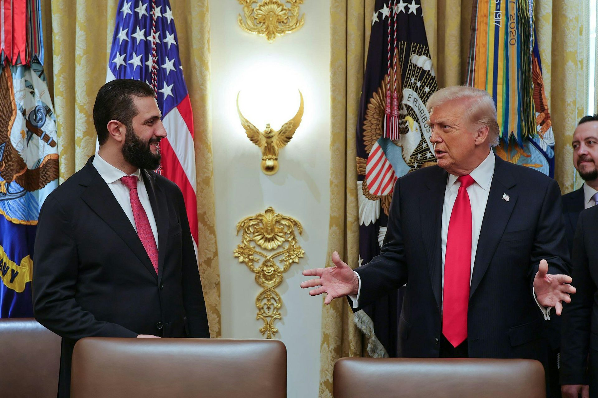 Donald Trump speaks with Ahmed al-Sharaa at the White House.
