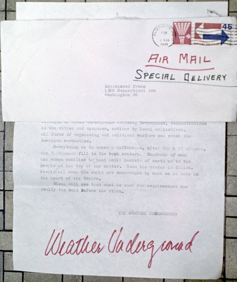 A page from a letter signed in red pen, 'Weather Underground,' claiming to have perpetrated a bombing of the U.S. Capitol building.