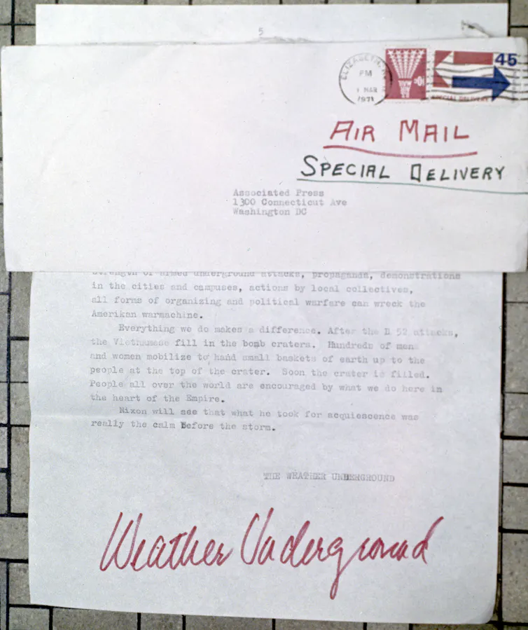 A page from a letter signed in red pen, 'Weather Underground,' claiming to have perpetrated a bombing of the U.S. Capitol building.