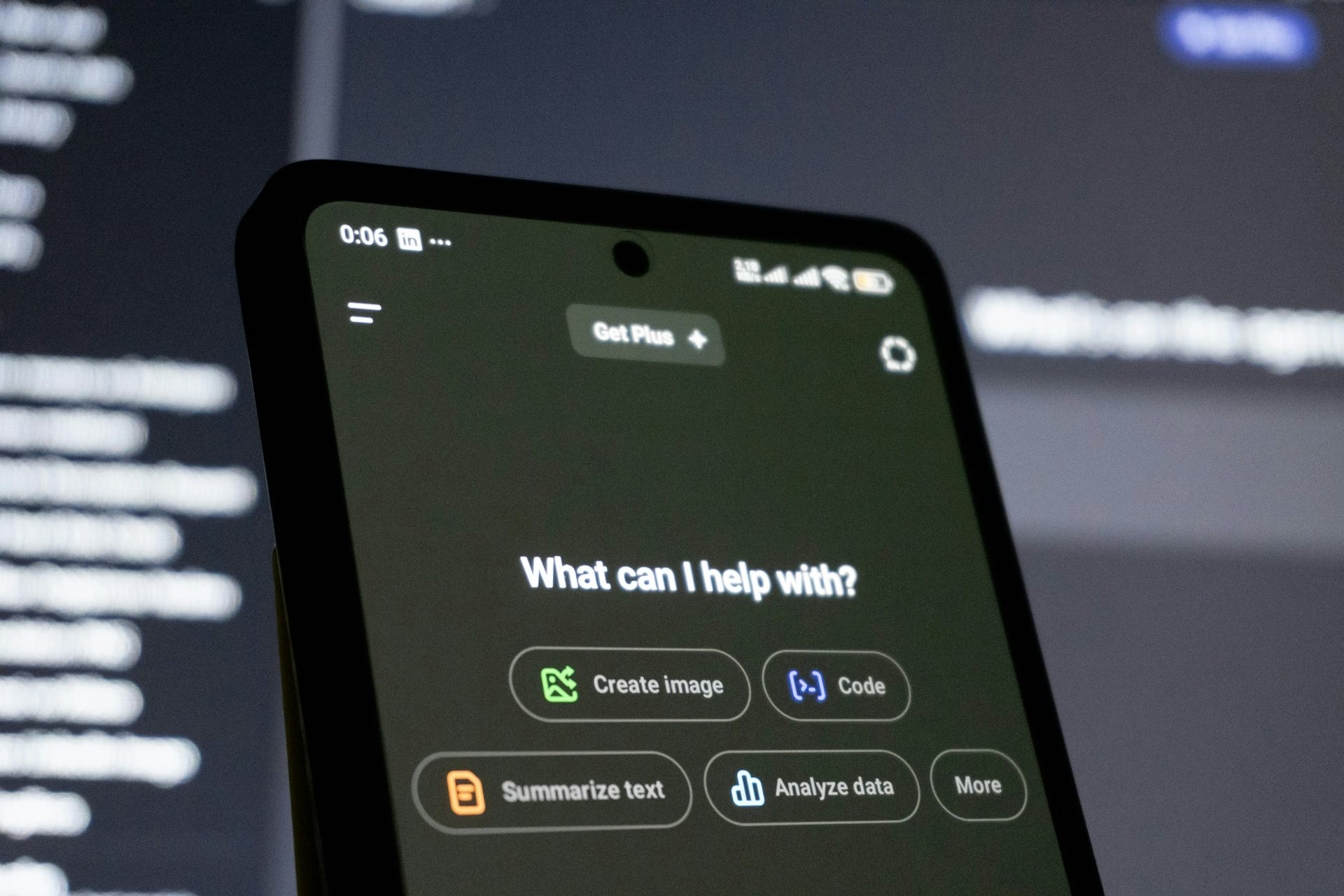 A smartphone screen displaying an AI screen reading 'What can I help with?'