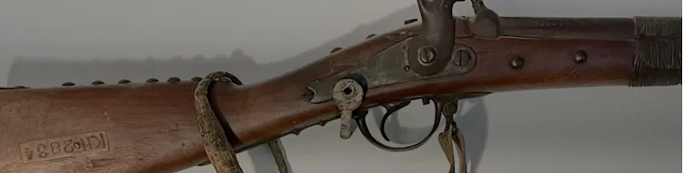 An old rifle made from wood and metal.