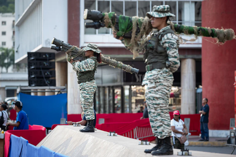 Two weapon-carrying members of Venezuela's Bolivarian Militia stand guard during a pro-government demonstration.