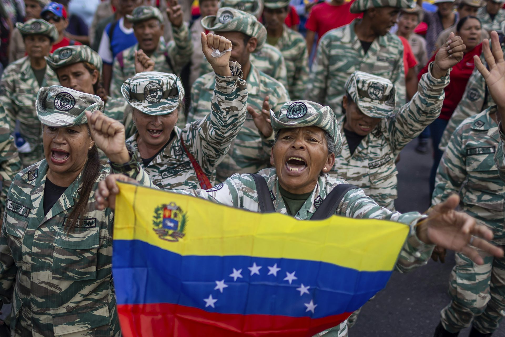 Members of Venezuela's Bolivarian militia hold a Venezuelan flag.