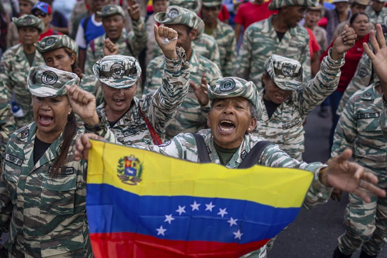 Trump’s Latin The us technique dangers developing an army quagmire 1 Members of Venezuela's Bolivarian militia hold a Venezuelan flag.