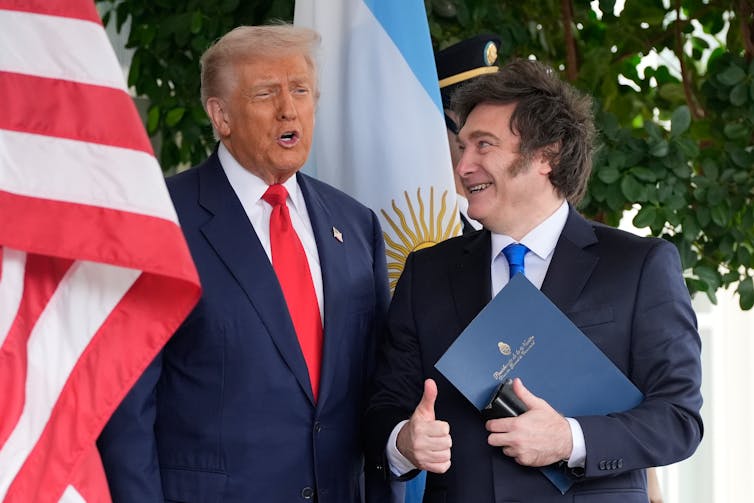 Farmers – lengthy Trump backers – undergo the prices of latest price lists, limited immigration and slashed renewable power subsidies 1 Two men in suits stand next to each other.
