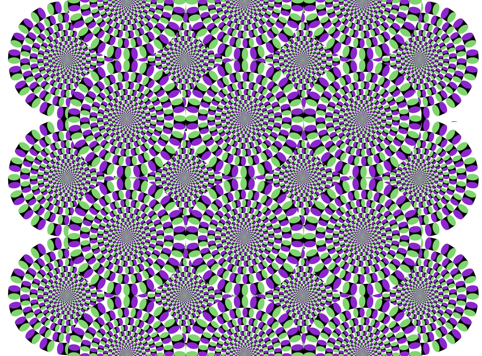 Vários círculos formados por ovais menores dispostos em uma grade, de forma que parecem estar girando lentamente. 