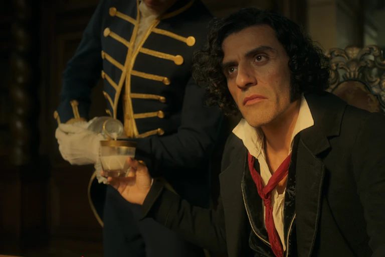 A film screenshot from the character of Frankenstein being poured a glass of milk.