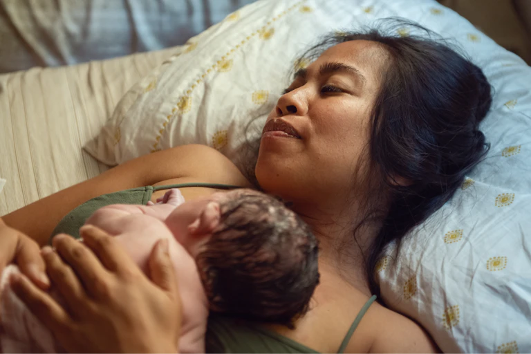 Woman holds her newborn