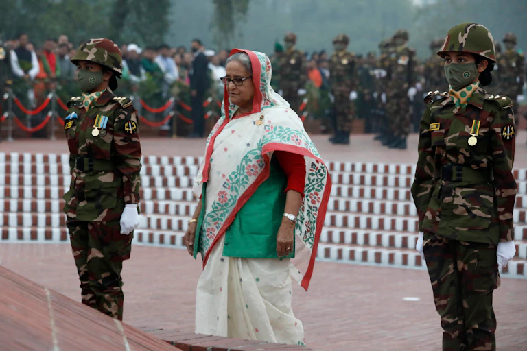 Sheikh Hasina pays tribute to dead soldiers during a memorial in Dhaka.