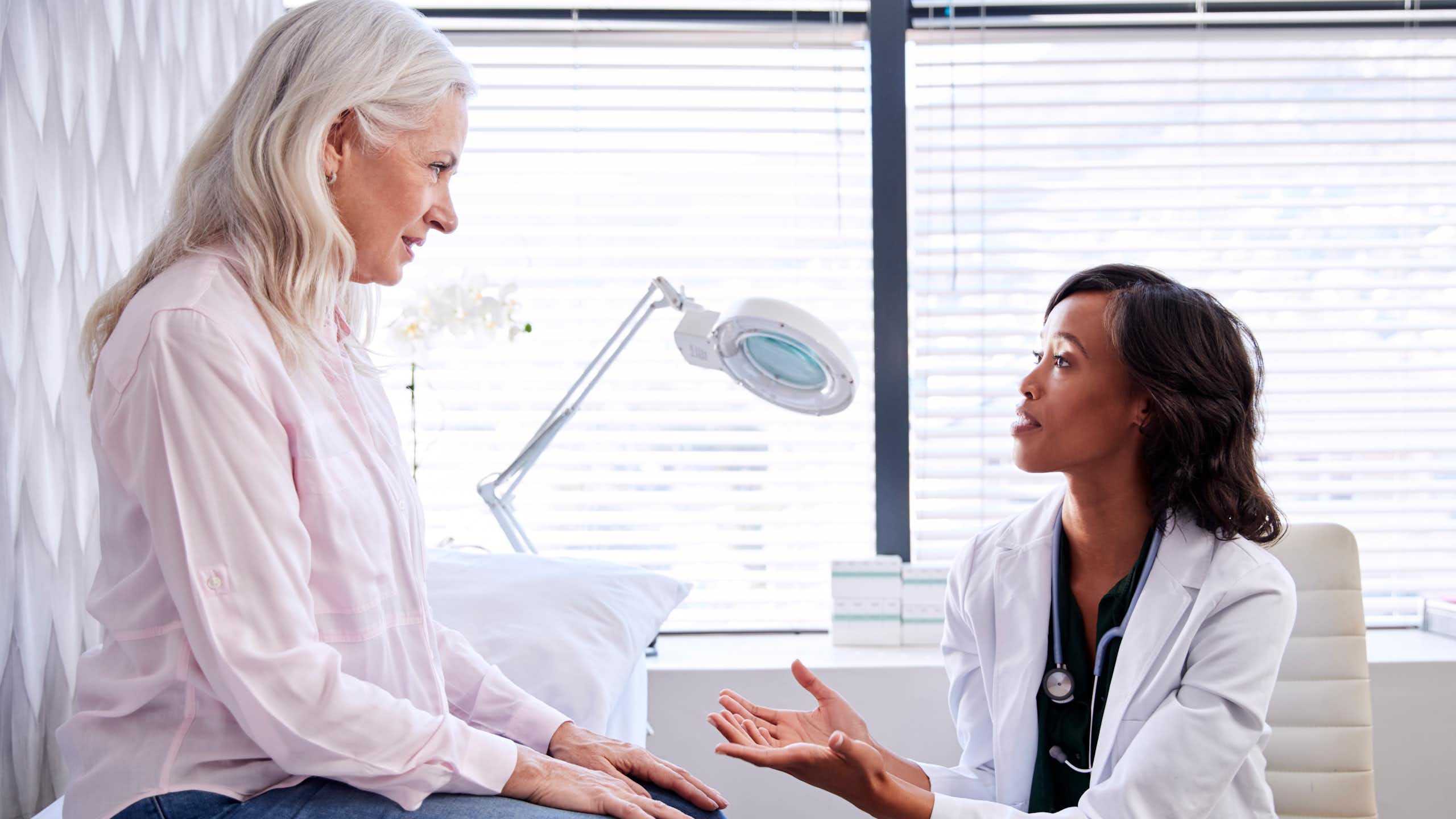 Mature patient speaking with her doctor