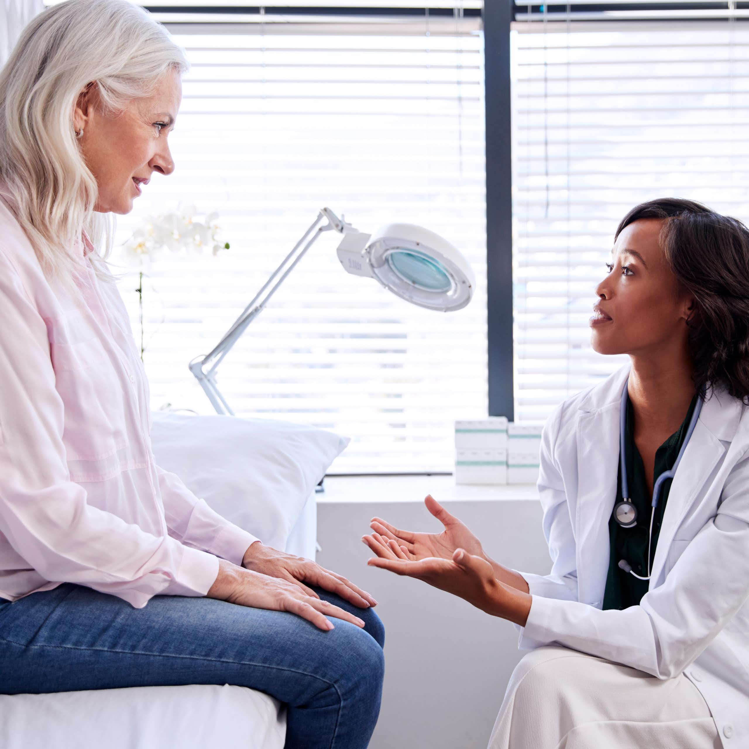 Mature patient speaking with her doctor