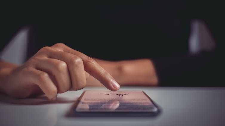 woman signing a contract on her phone