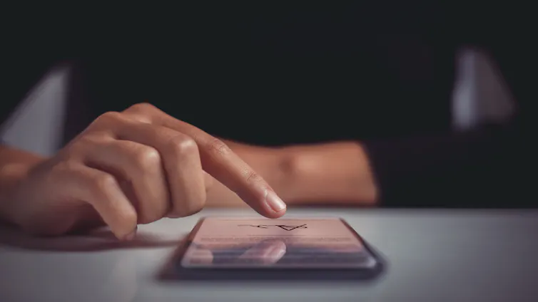 woman signing a contract on her phone