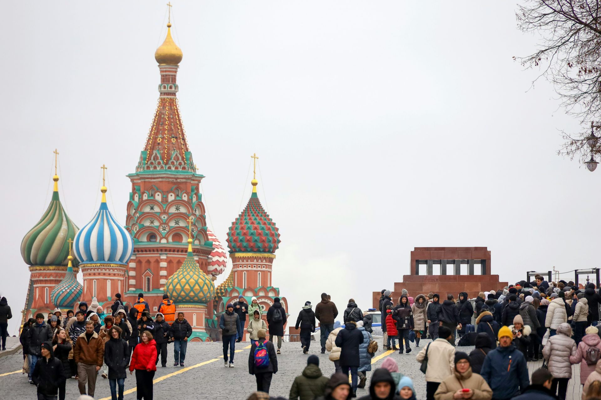People walk near the Kremlin in Moscow.