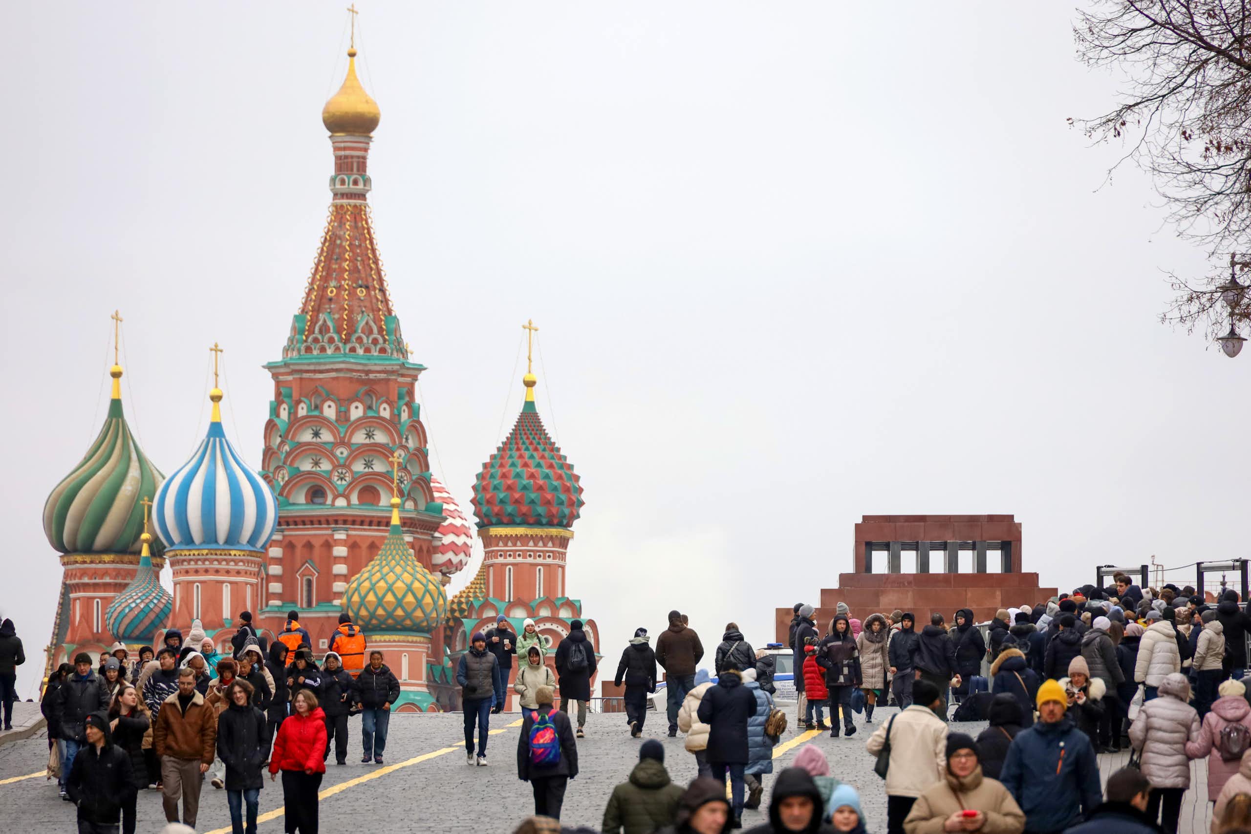 People walk near the Kremlin in Moscow.