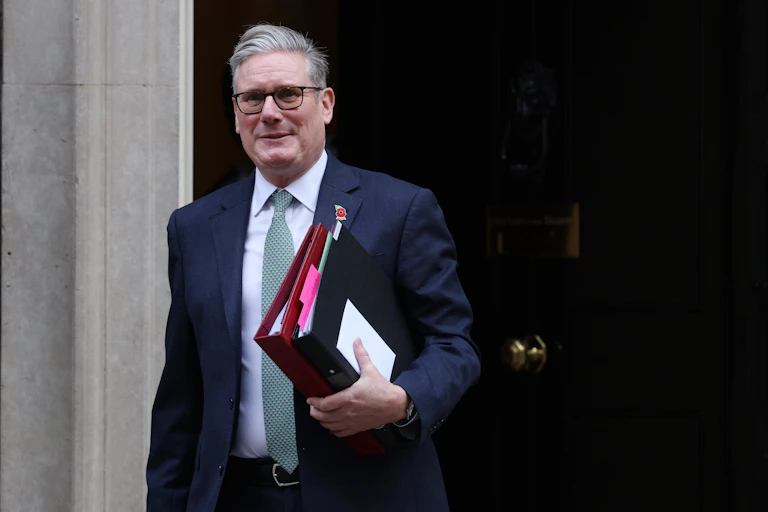 Keir Starmer walking out of Number 10 with binders
