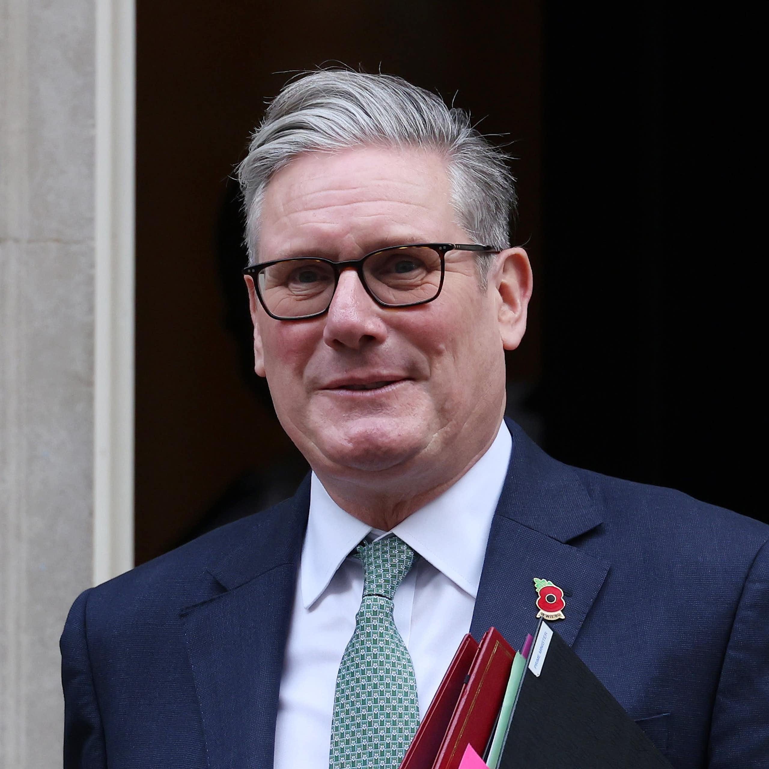 Keir Starmer walking out of Number 10 with binders