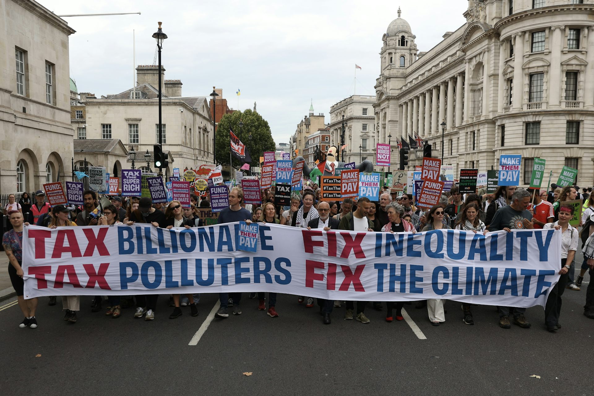 Demonstrators march with banners and placards during the "Make Them Pay" protest in London, United Kingdom on September 20, 2025. 