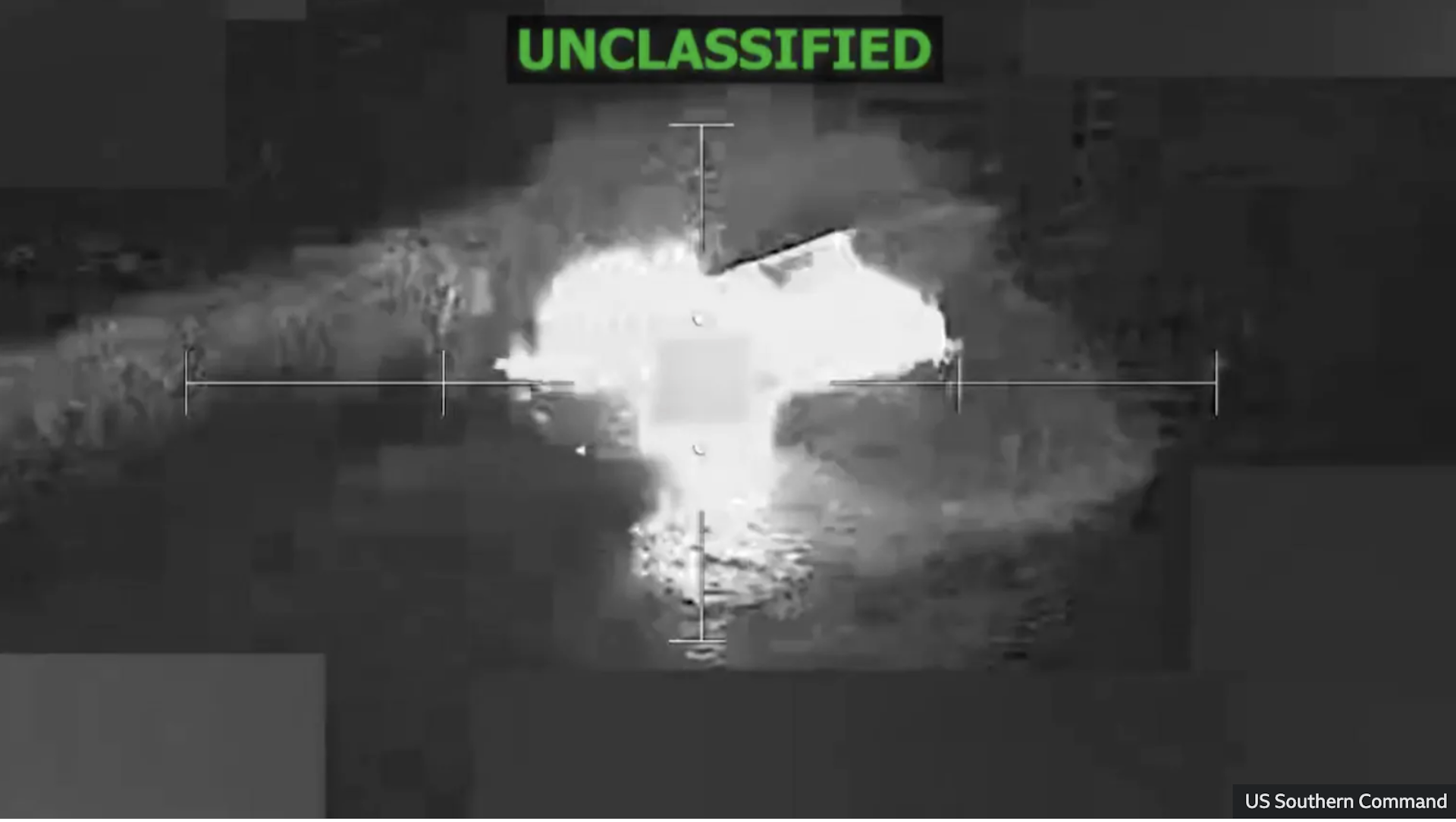 A screengrab from a video shows an aerial shot of an explosion. The word Unclassified is spelled in green at the top of the shot.
