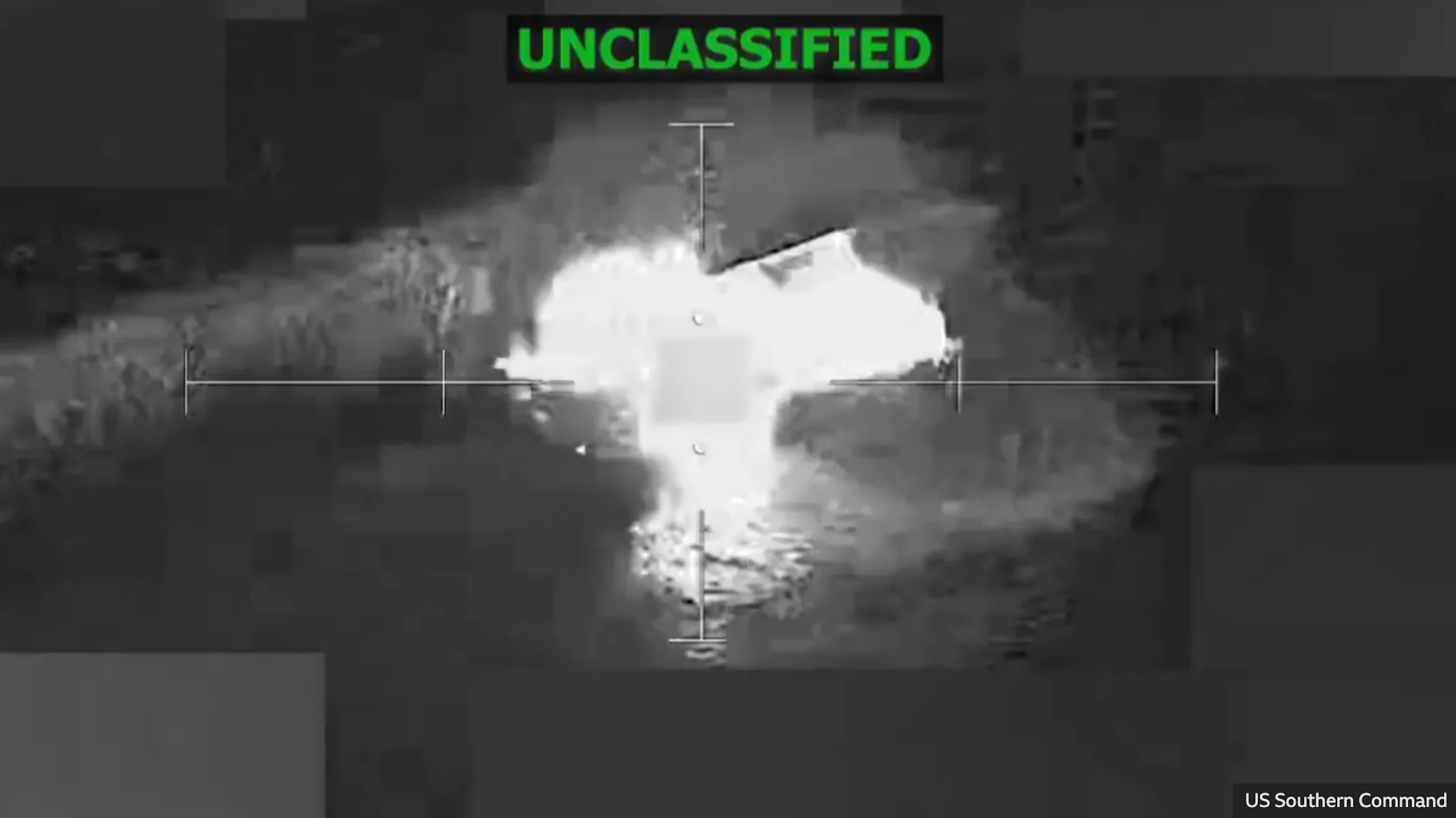 A screengrab from a video shows an aerial shot of an explosion. The word Unclassified is spelled in green at the top of the shot.