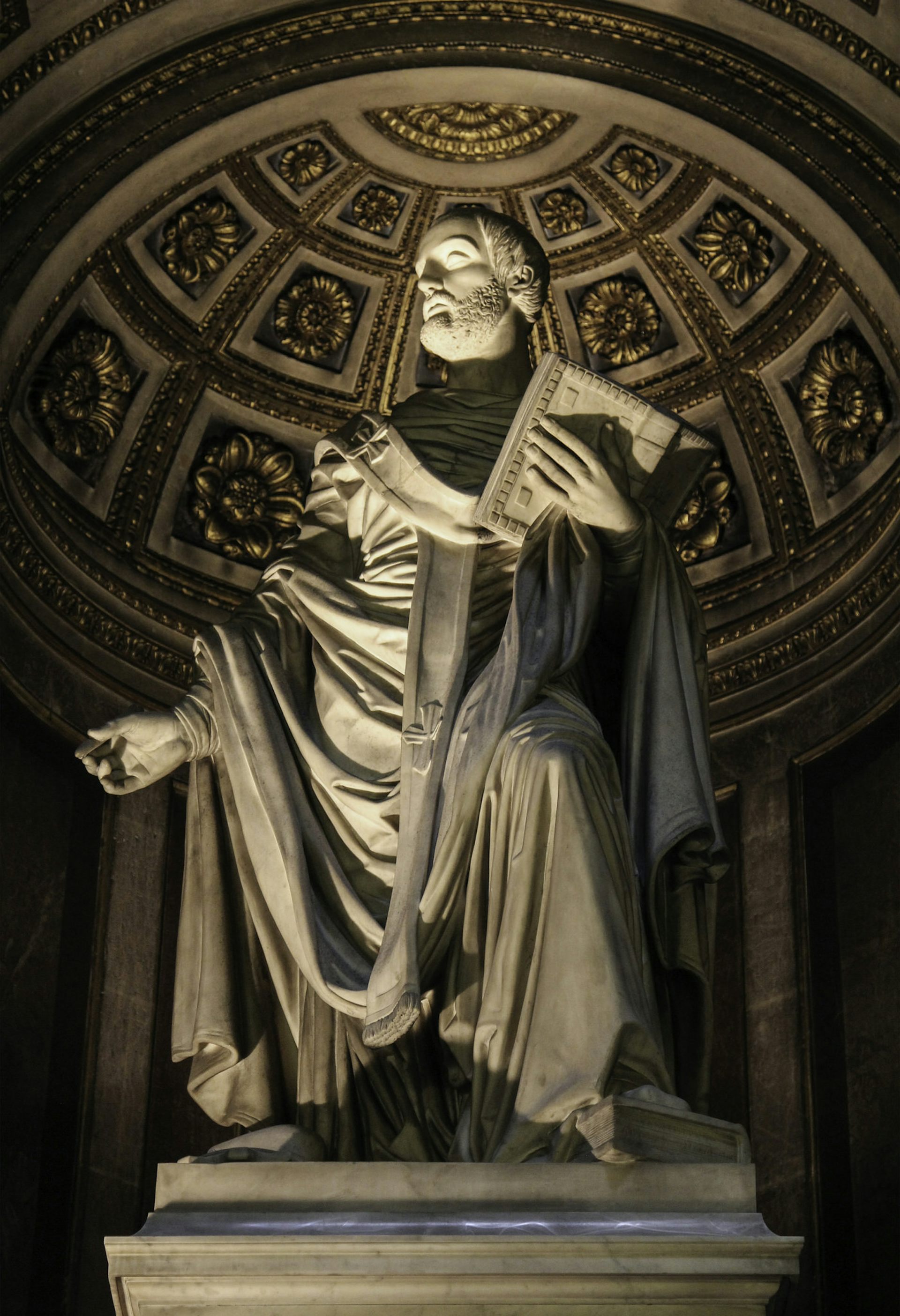 A stone statue of a bearded man in robes.