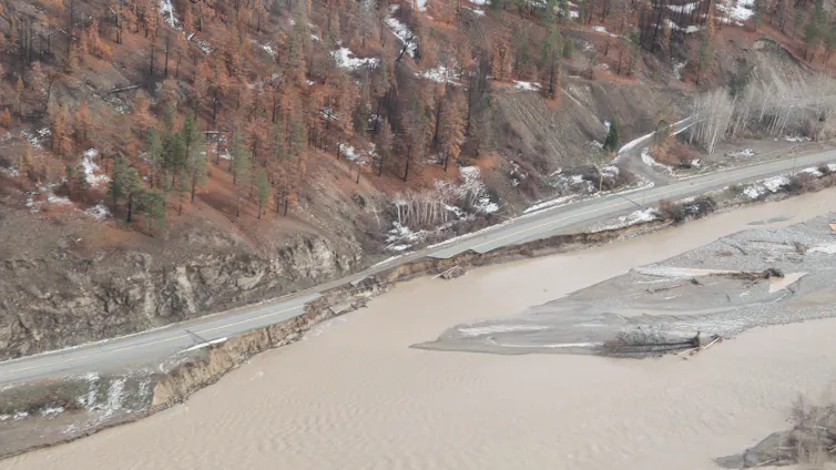 Muddy floodwaters submerge a highway