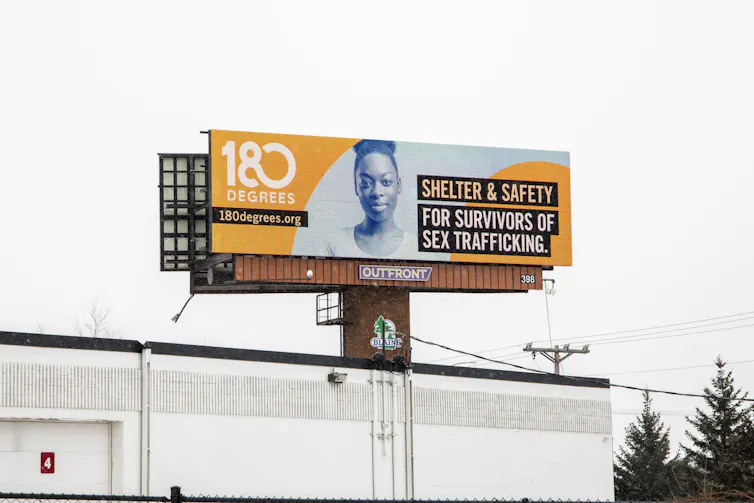 A billboard advertises for help for survivors of sex trafficking.