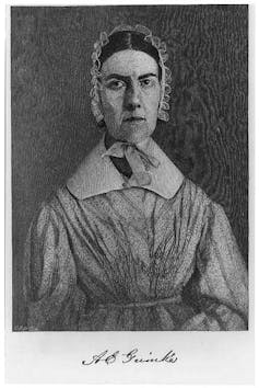 a woman in a bonnet poses for a photograph