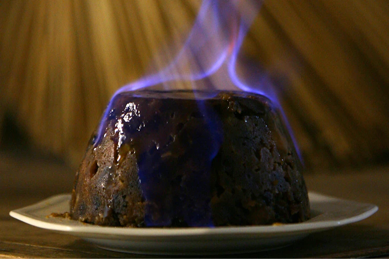 Blue flames emanate from a pudding.