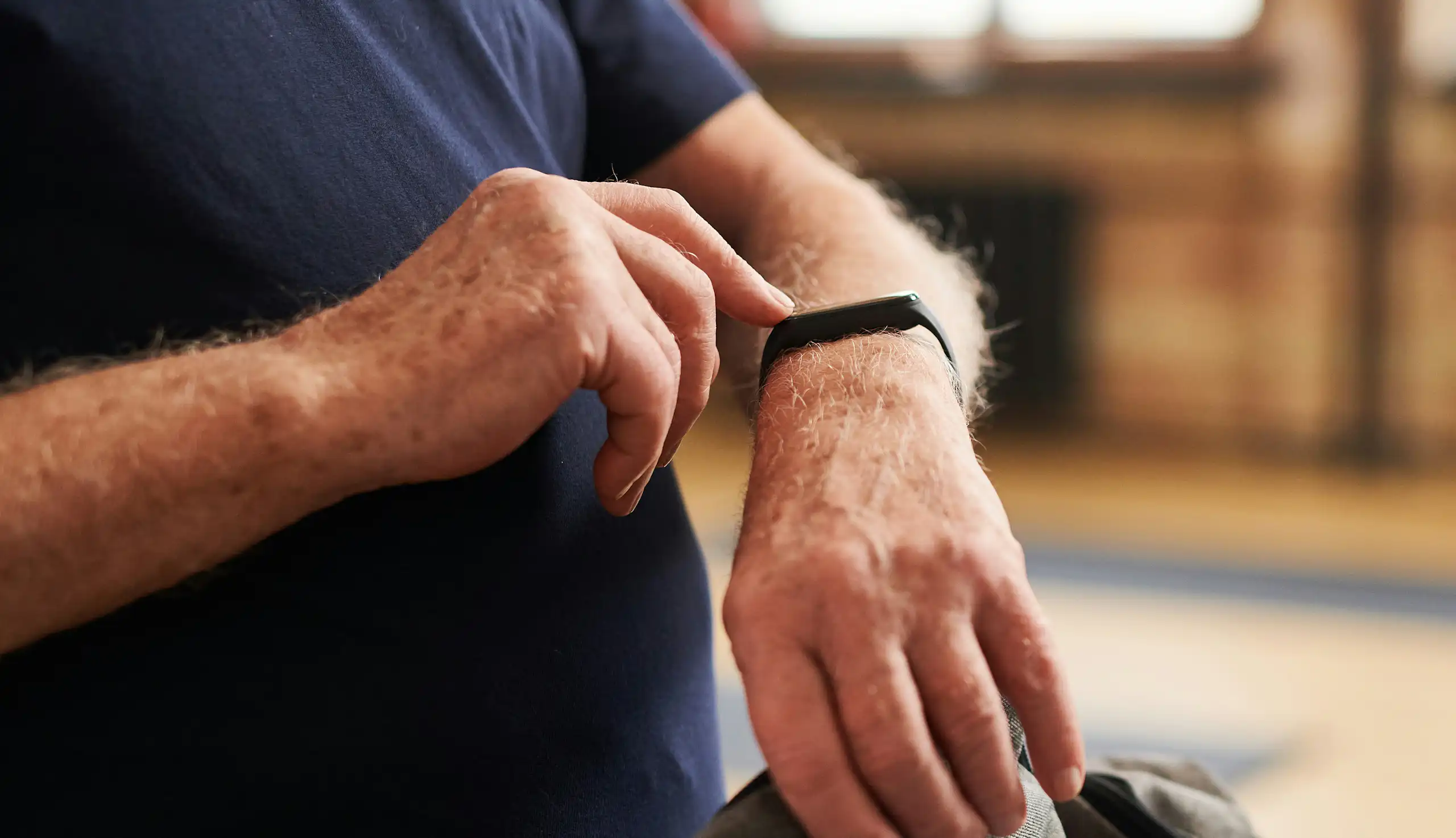 An person touching a smartwatch on their wrist