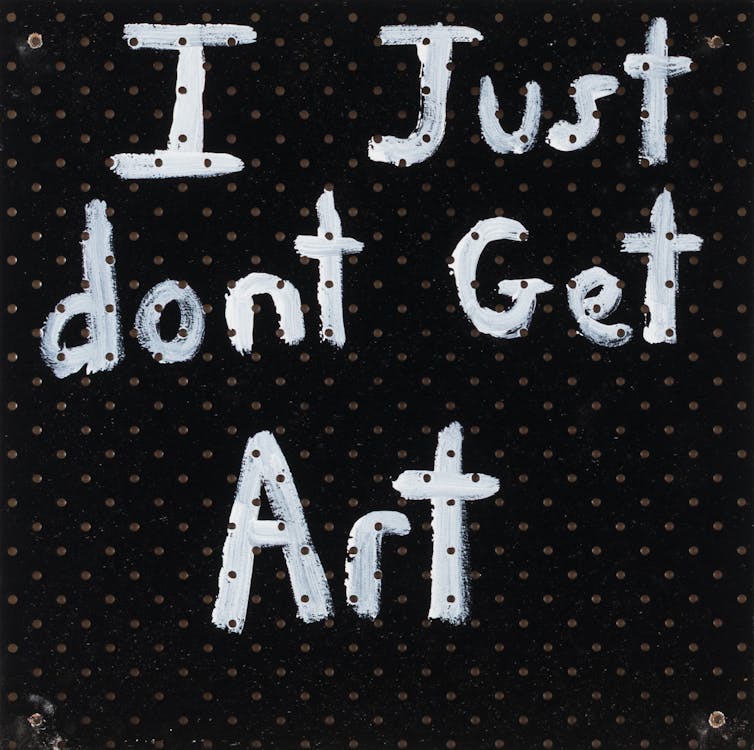 A black panel reads 'I Just don't Get Art' written in in thick white paint.