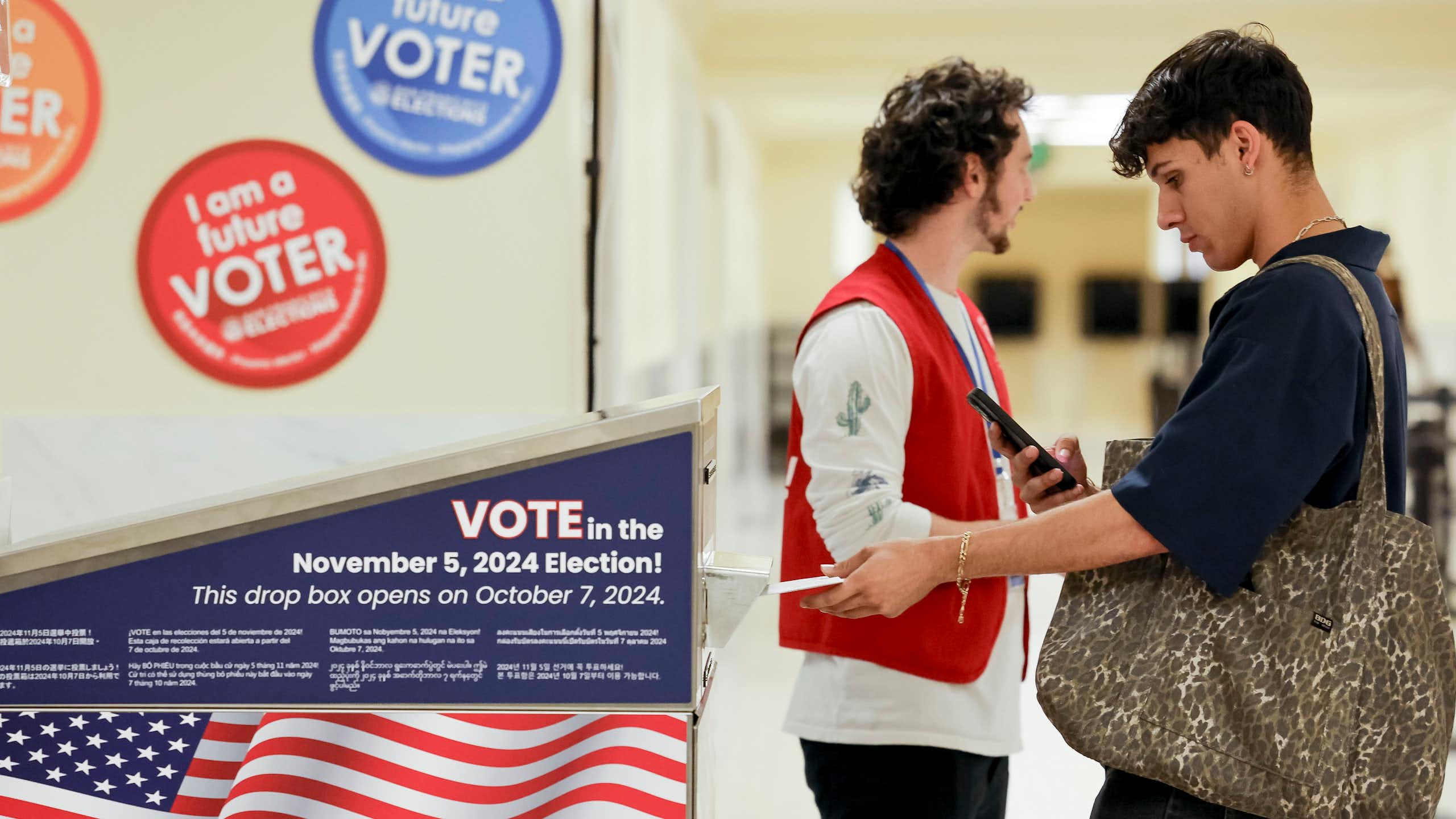 Two young men at a voting booth for the US 2024 presidential election.