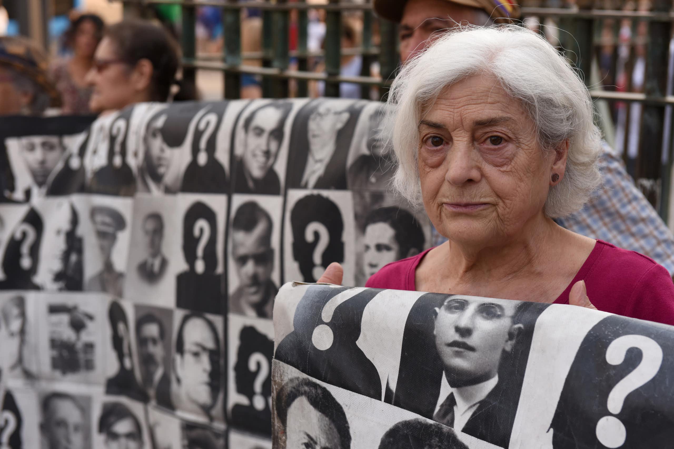 A woman holds a sign at a protest.
