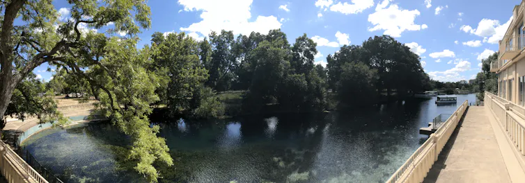 A panorama photo of a lake next to a building