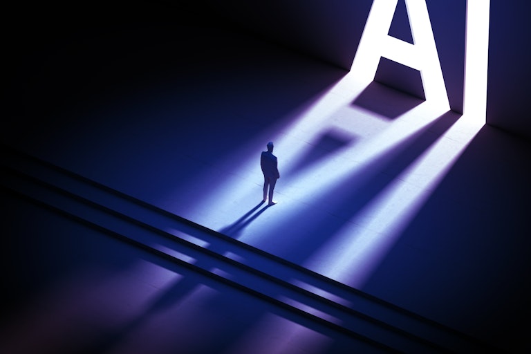 A silhouette of a man standing before two large, bright letters: 'A' and 'I.'