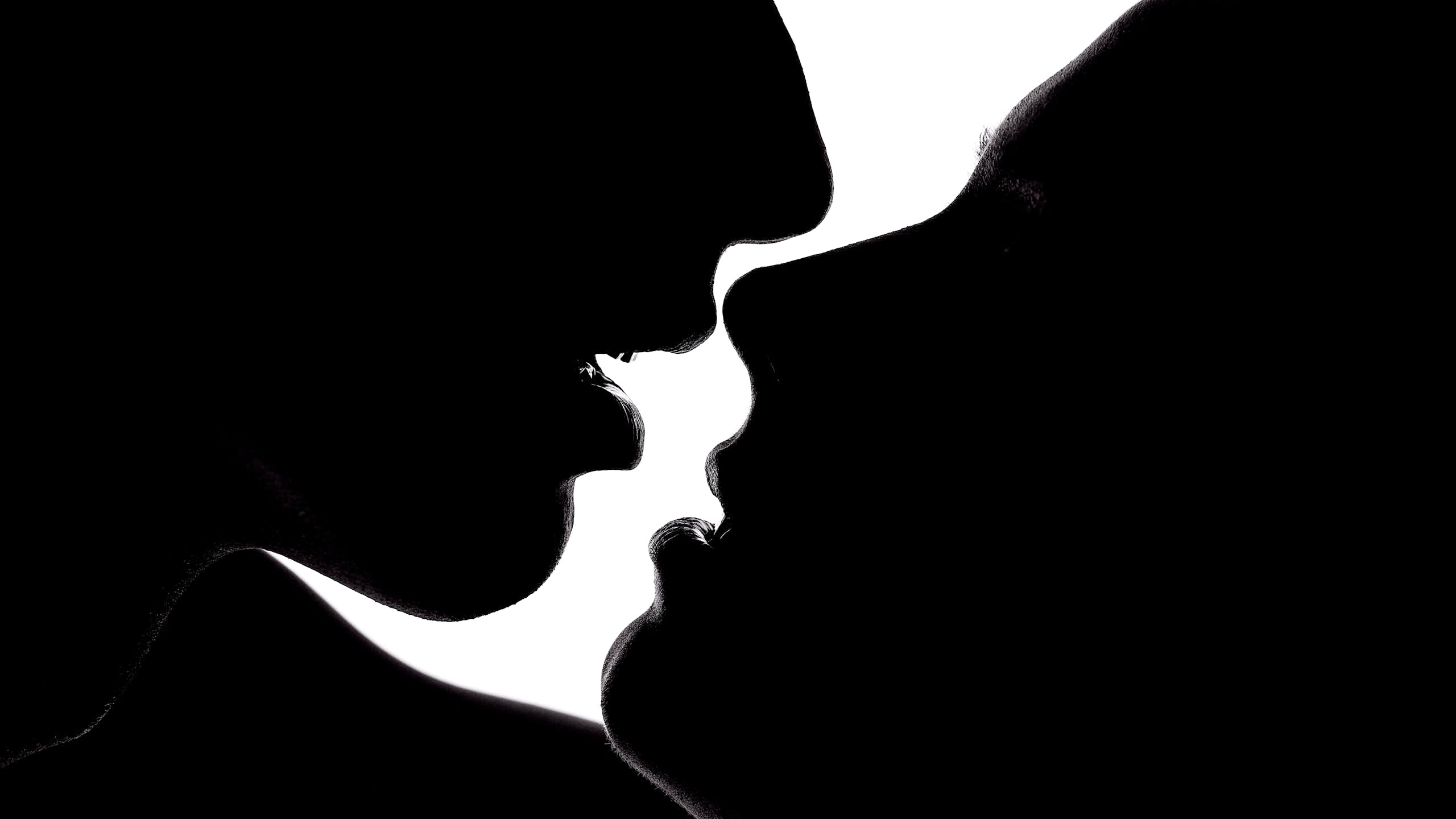 Black and white photo of young couple about to kiss