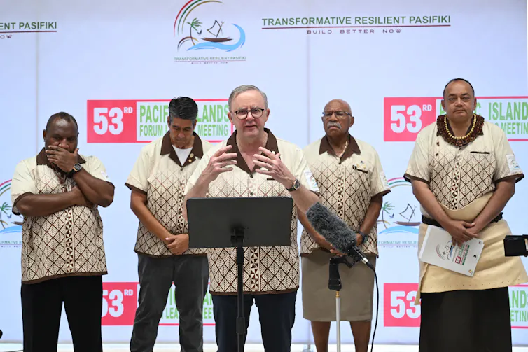 leaders standing at podium.