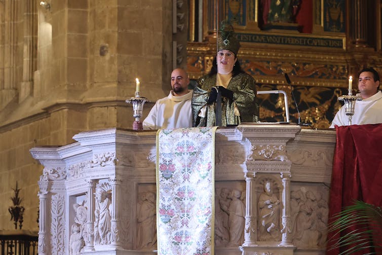 A woman sings from a church podium.