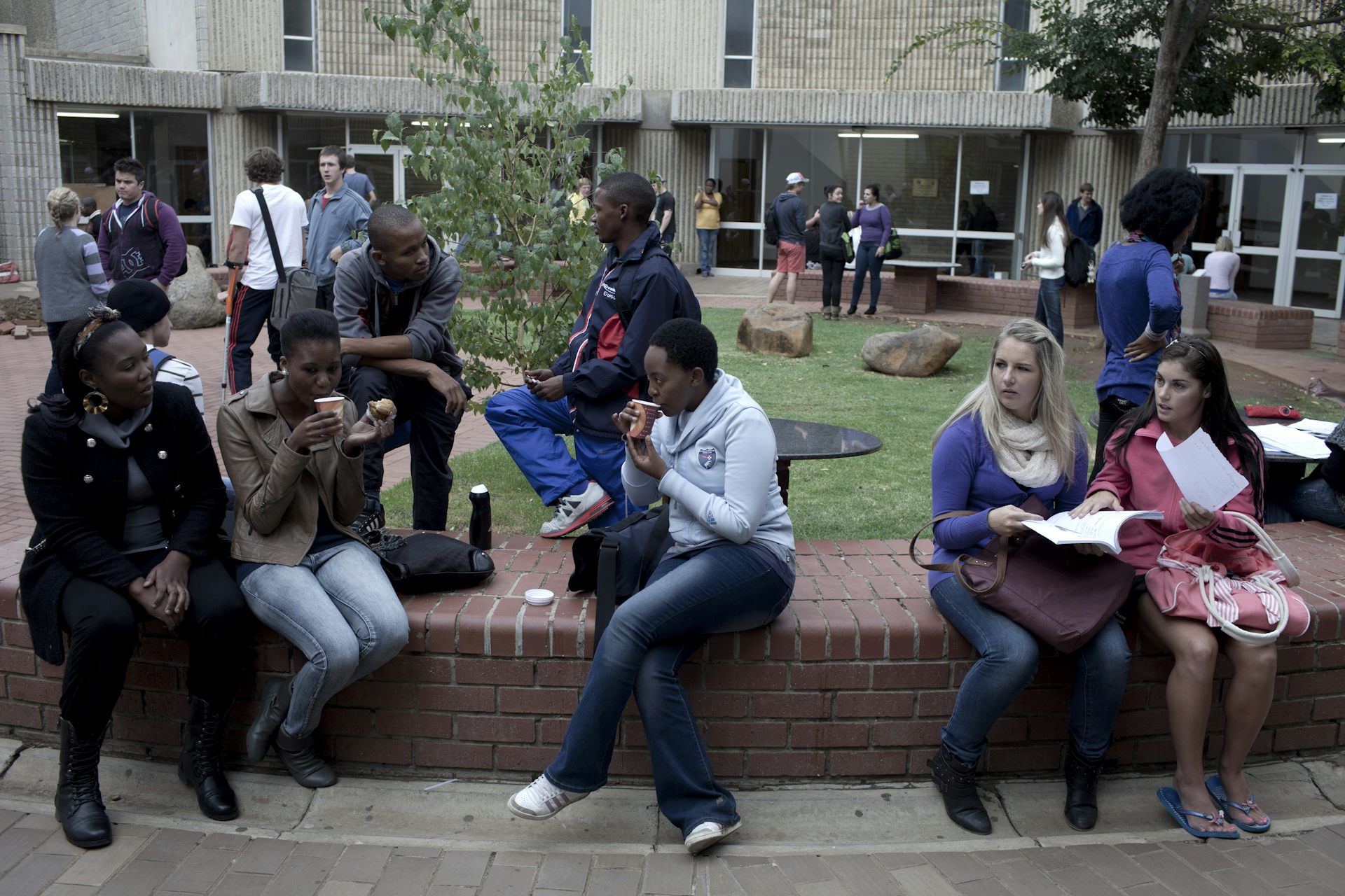 A group of students chatting outside lecture halls 