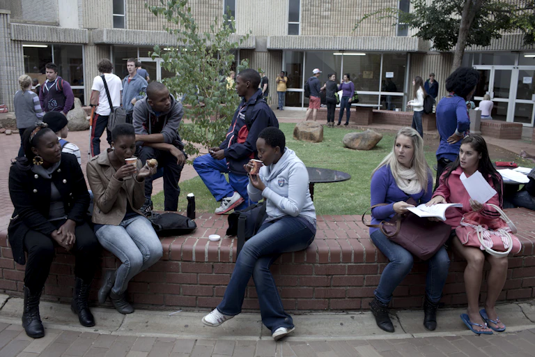 A group of students chatting outside lecture halls