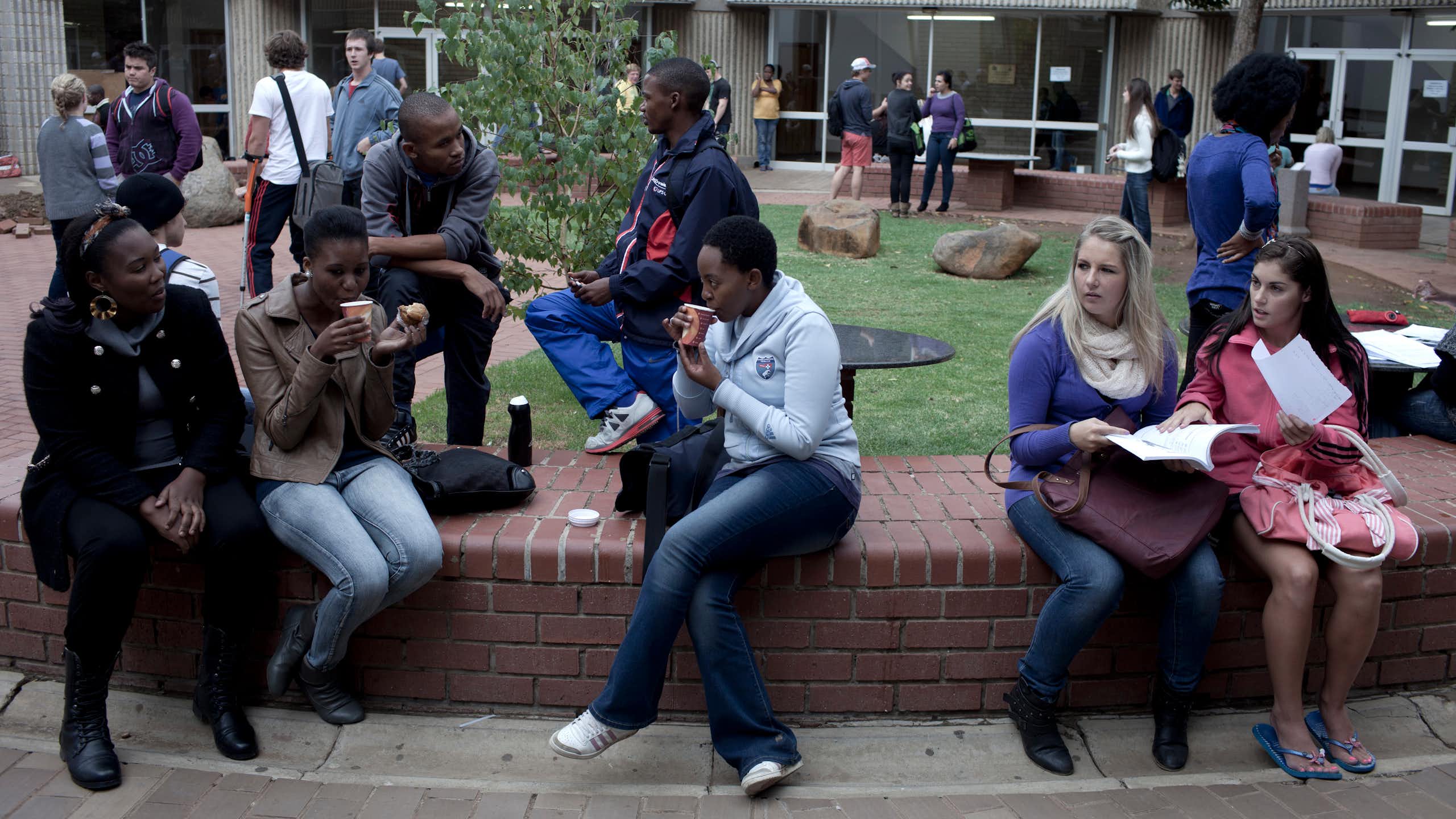 A group of students chatting outside lecture halls