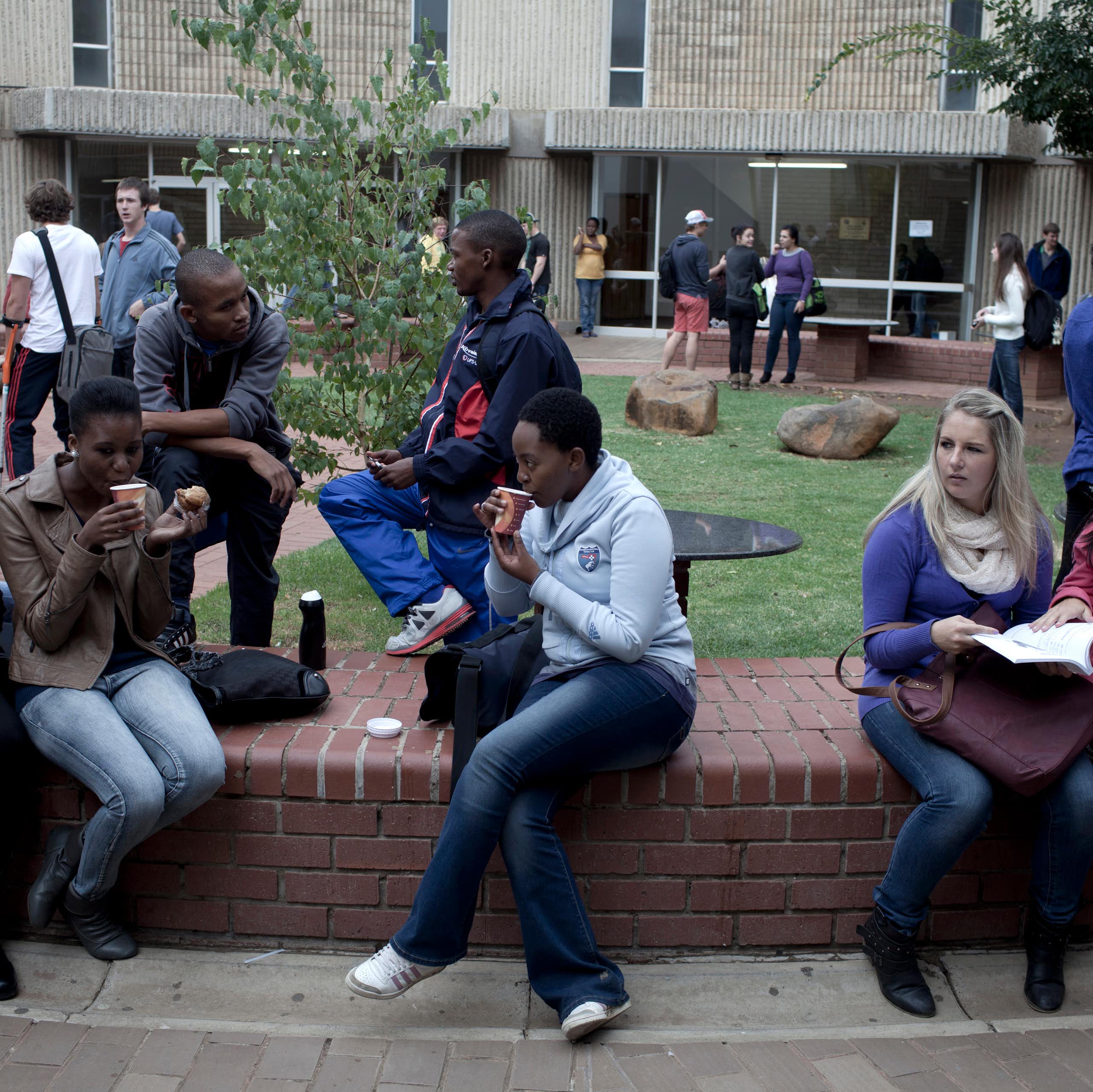 A group of students chatting outside lecture halls